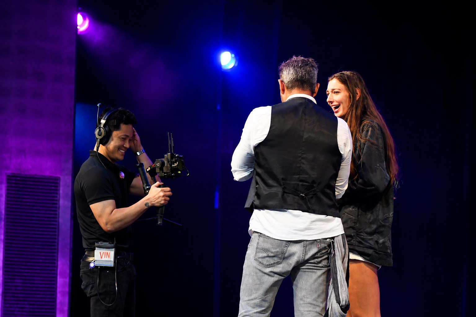 Phoenix talking a volunteer through the show on stage
